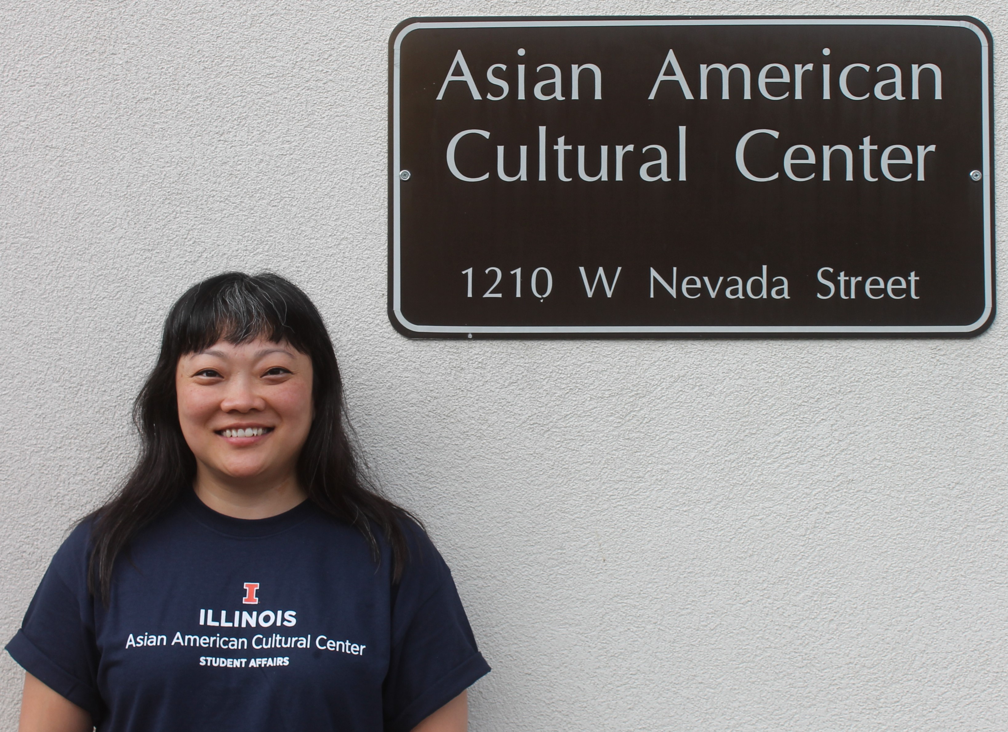 Photo of Sang Lee Assistant Director in front of AACC building sign